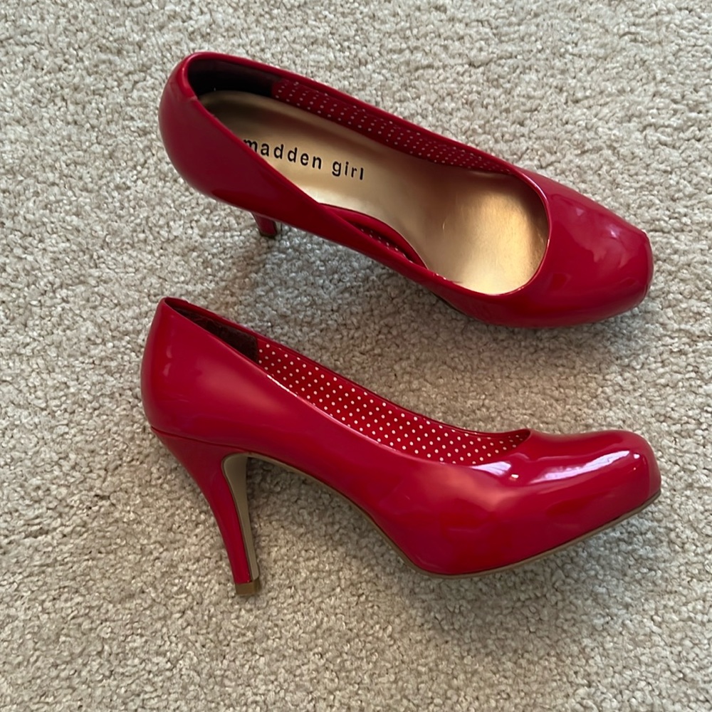Red heels with small scuff on left heel (3/4 in).